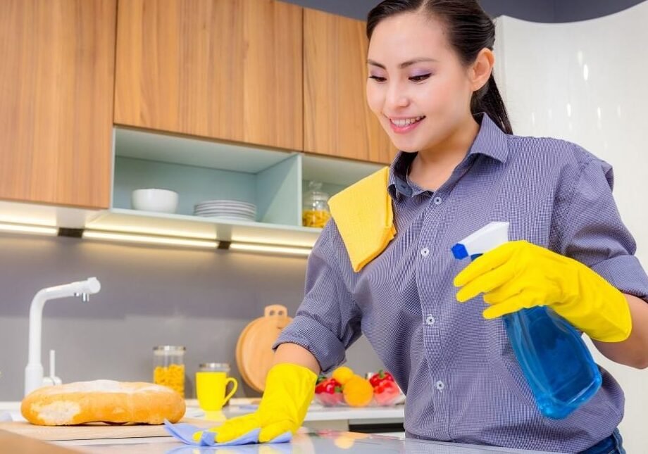 Expert maid cleaning kitchen